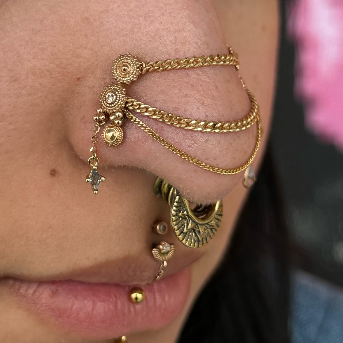 Healed gold nose and septum piercing curation by Frankie at Dandyland
