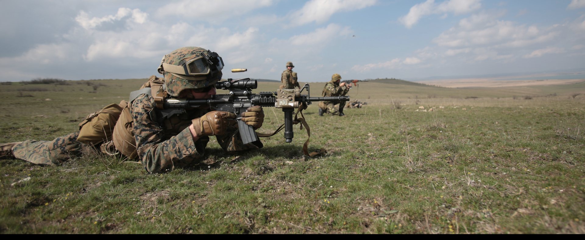 A Marine in the prone firing downrange during a combined training exercise