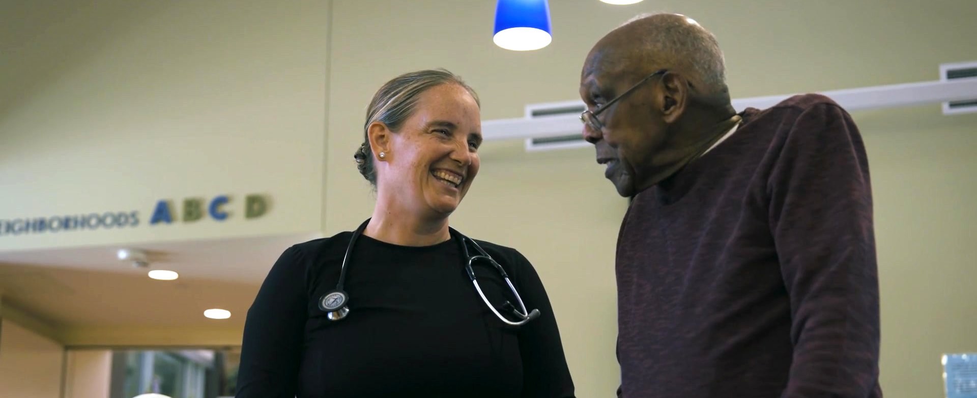 A nurse and a resident share a laugh at a Washington State Veterans Home